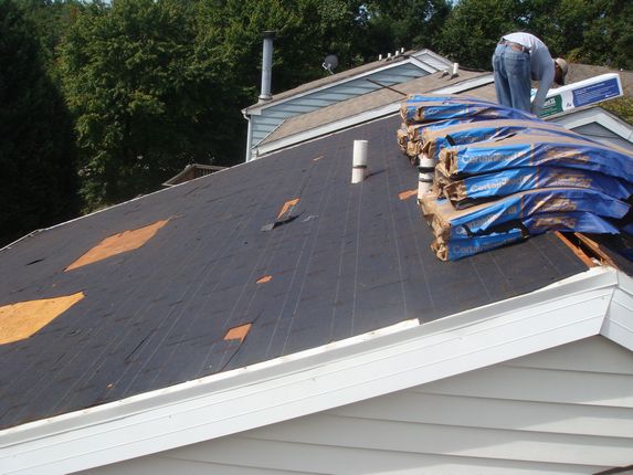 Old roofing felt being removed